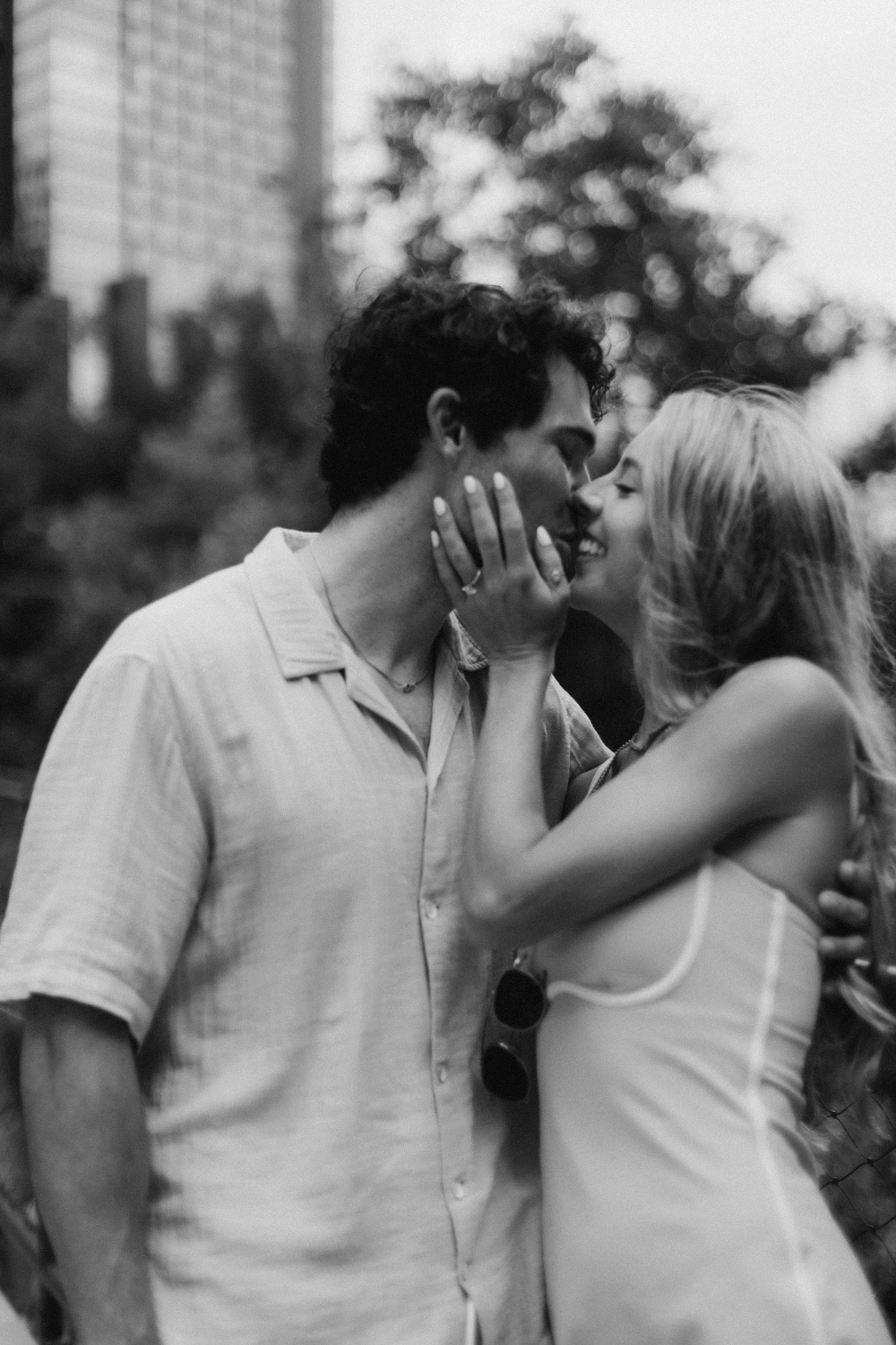 A black and white kiss under the trees