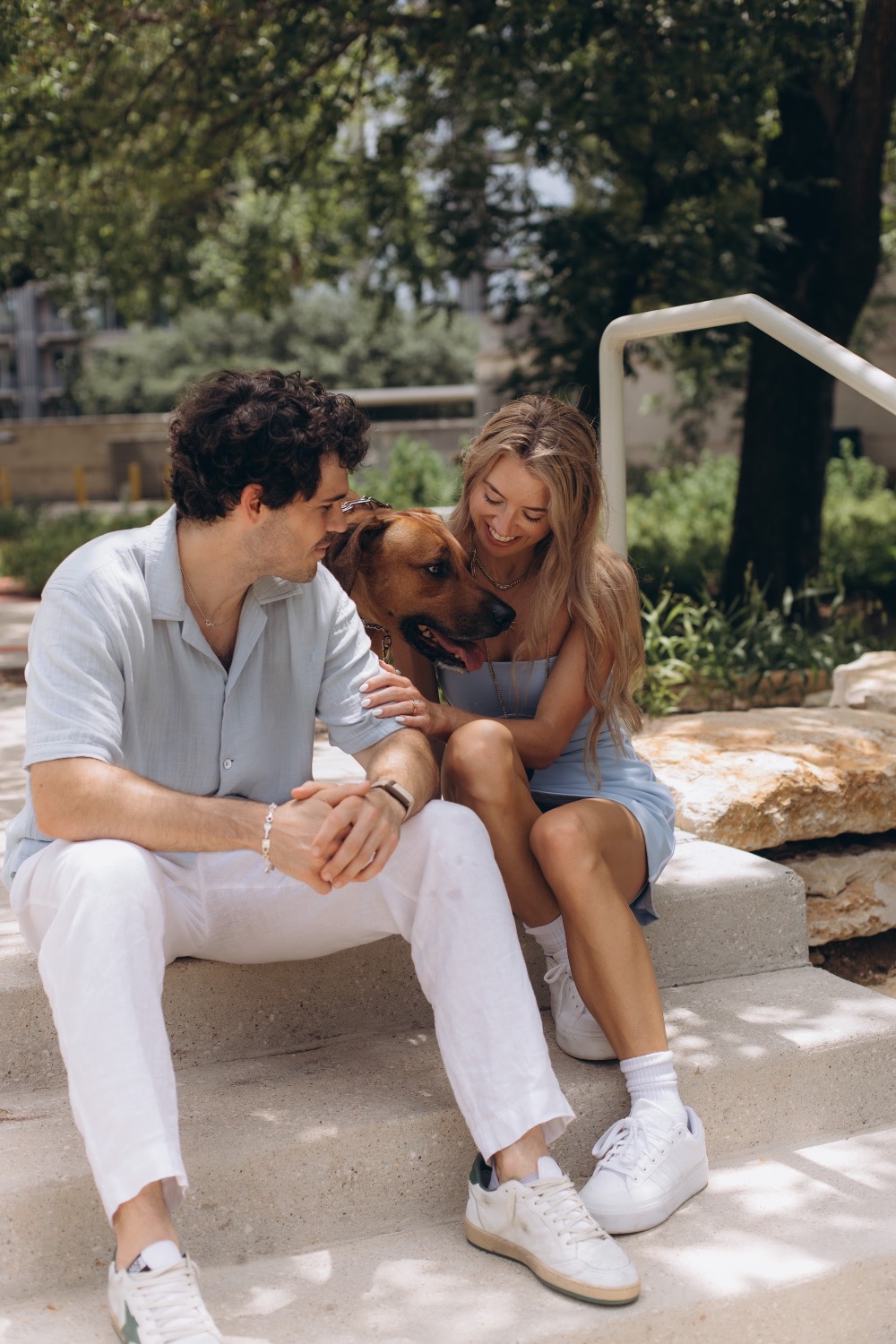 Hunter and Mary sitting with their dog at the park