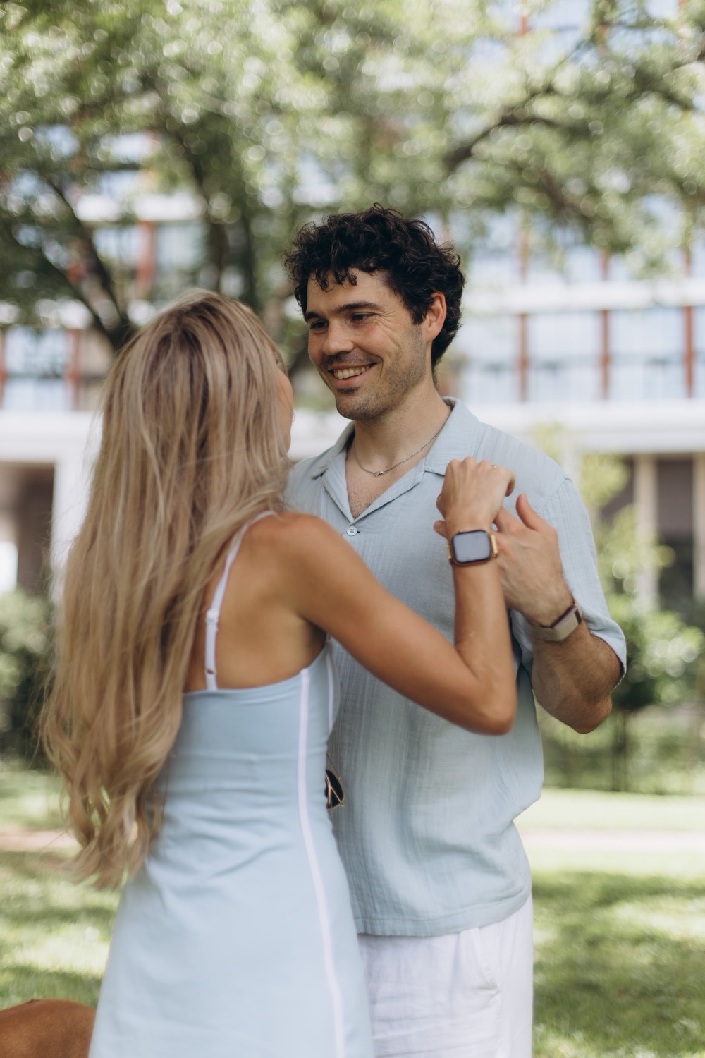 Mary's hands resting on Hunter's shoulder, engagement ring showing