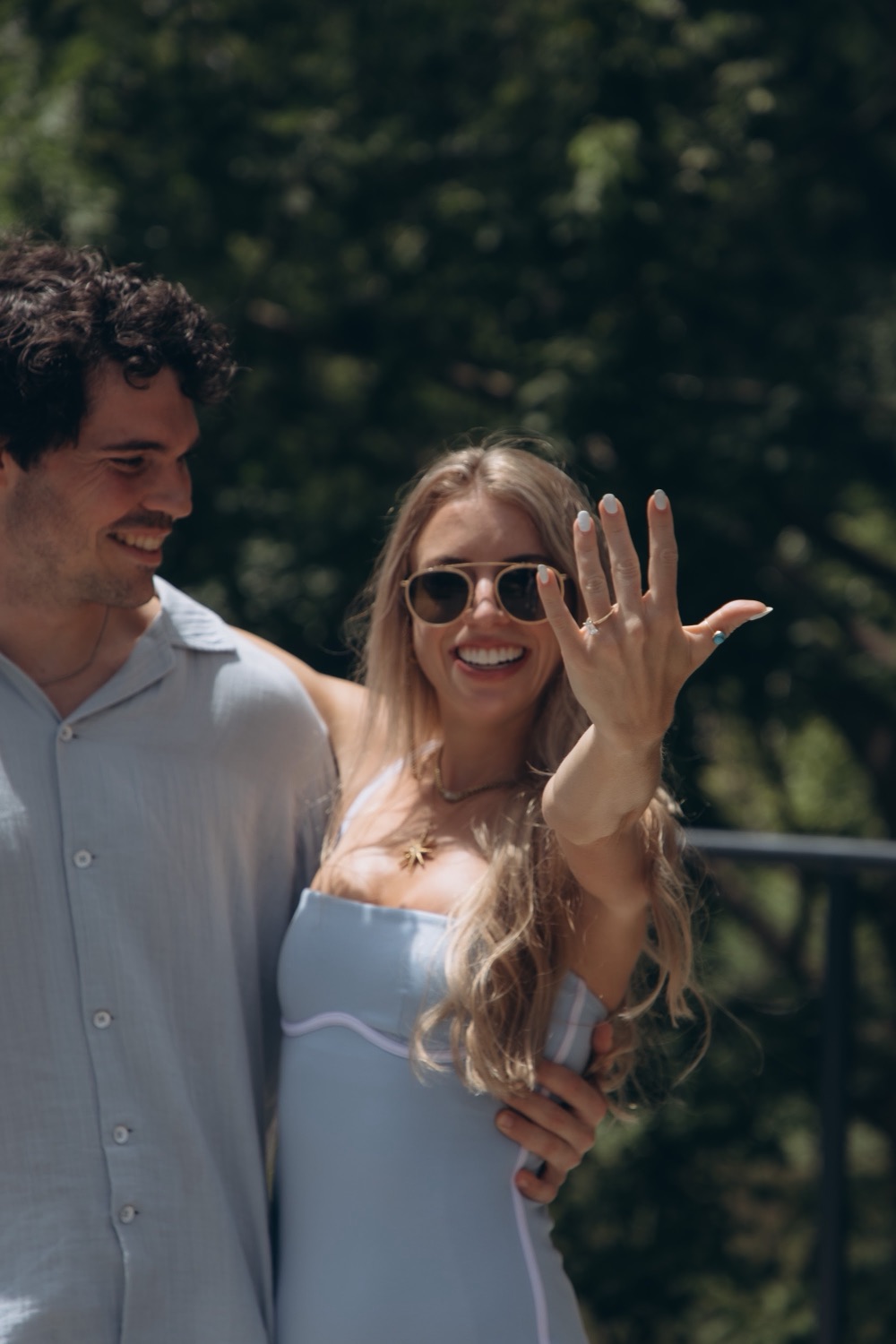 Mary showing off her engagement ring while Hunter smiles