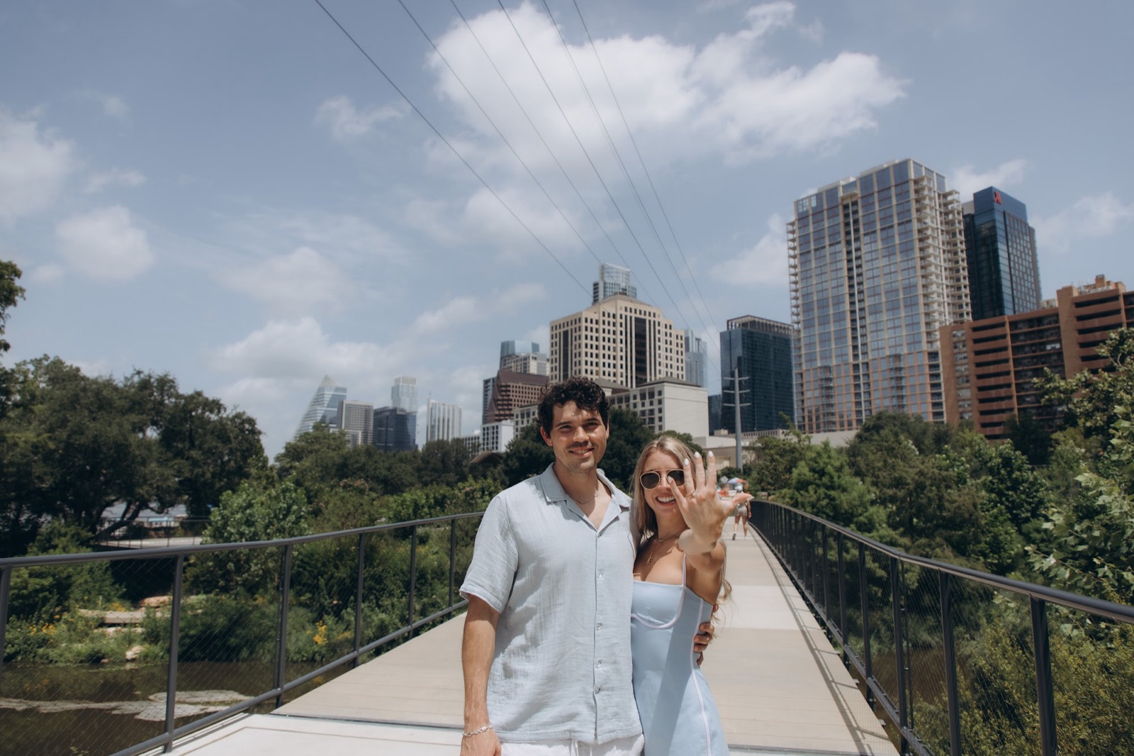 Hunter and Mary on the pedestrian bridge with the Austin skyline behind