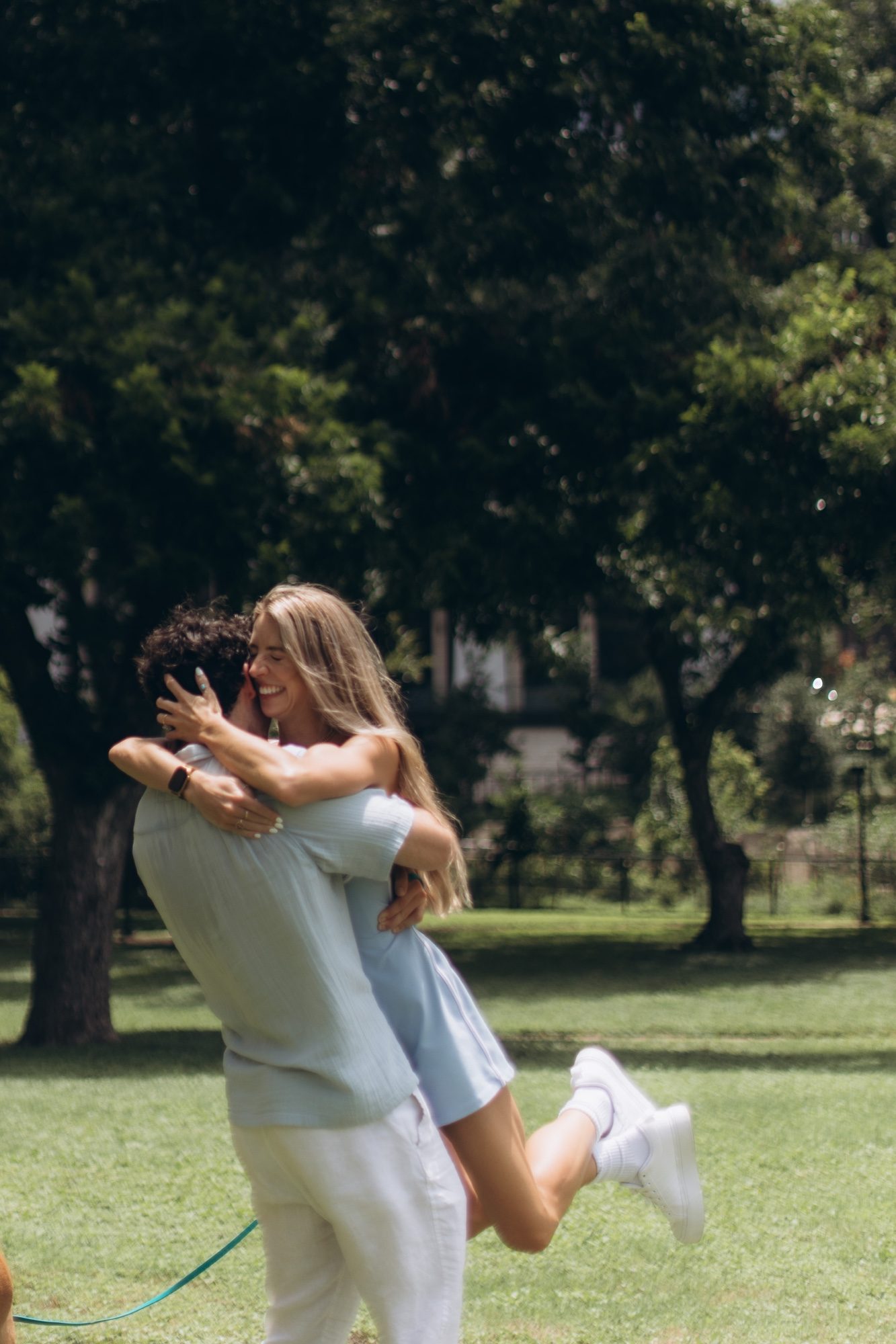 Hunter lifting Mary into a hug in the park