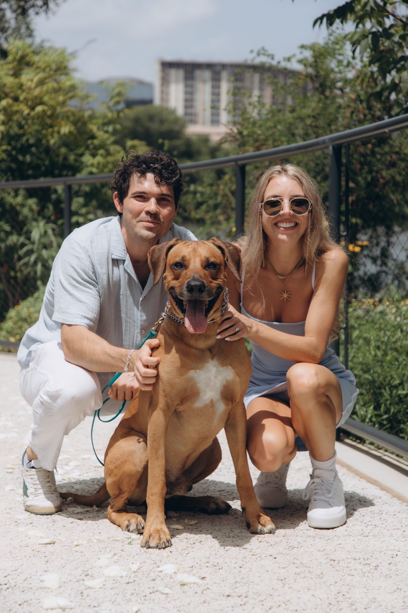 Hunter and Mary crouching beside Obi for a family portrait