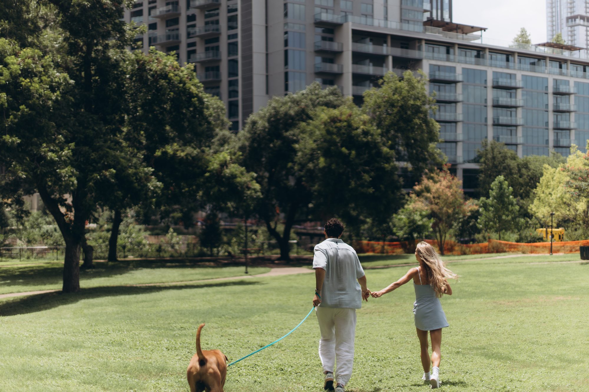 Hunter and Mary walking through the park with Obi