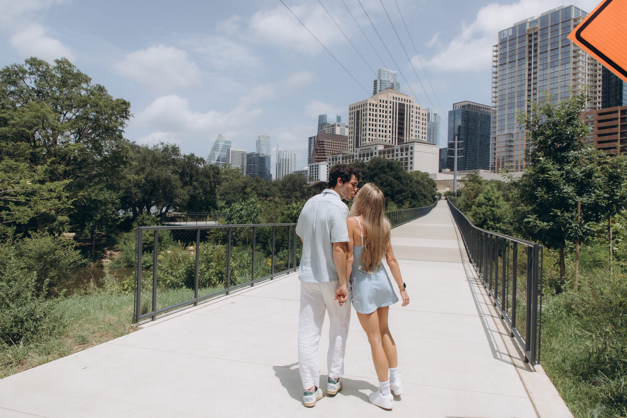 Hunter kissing Mary on the head as they walk away together on the bridge