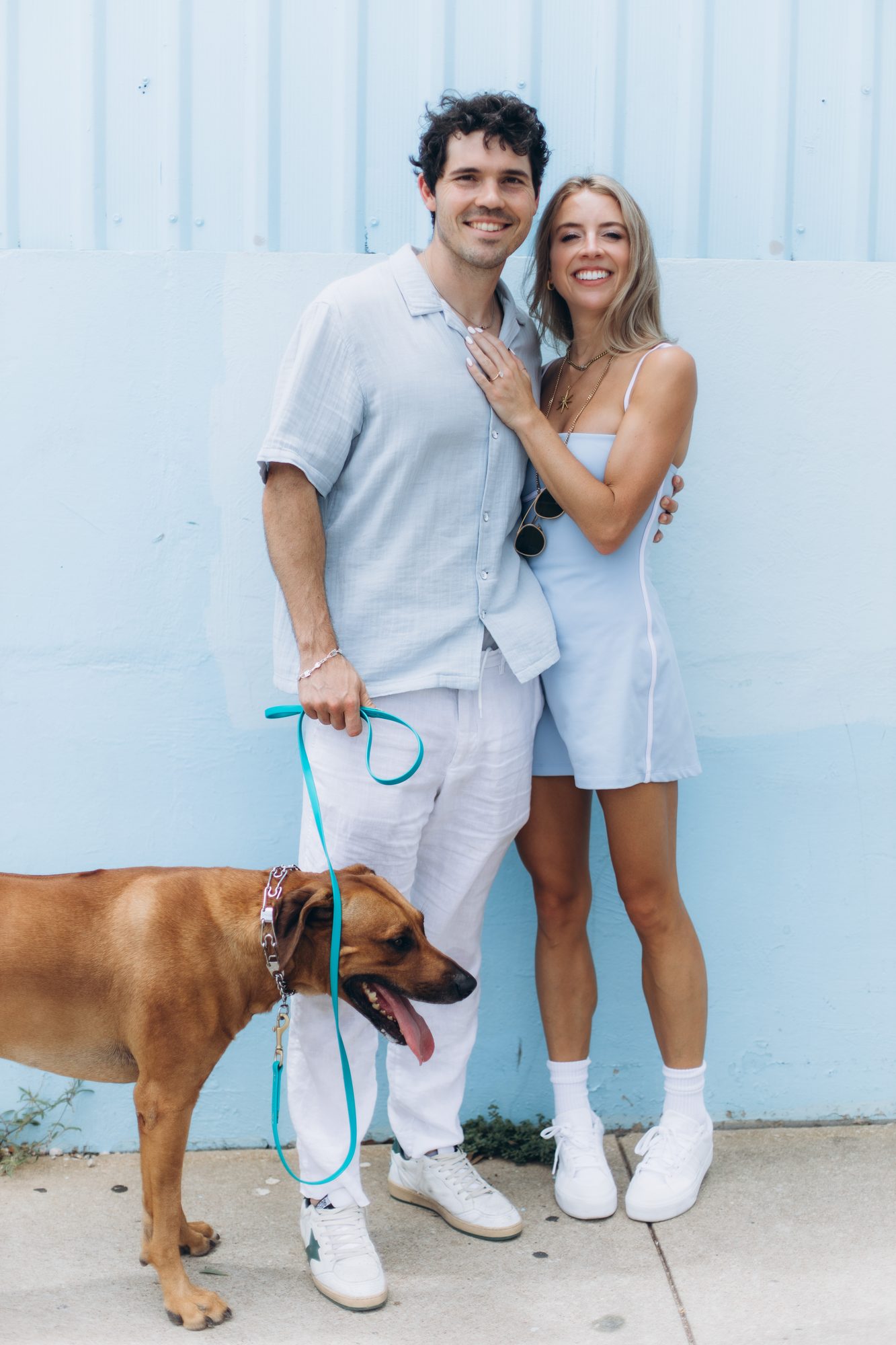 Hunter and Mary with Obi beside a wall
