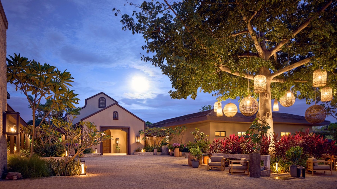 The lantern-lit ceiba courtyard at Nekajui at dusk