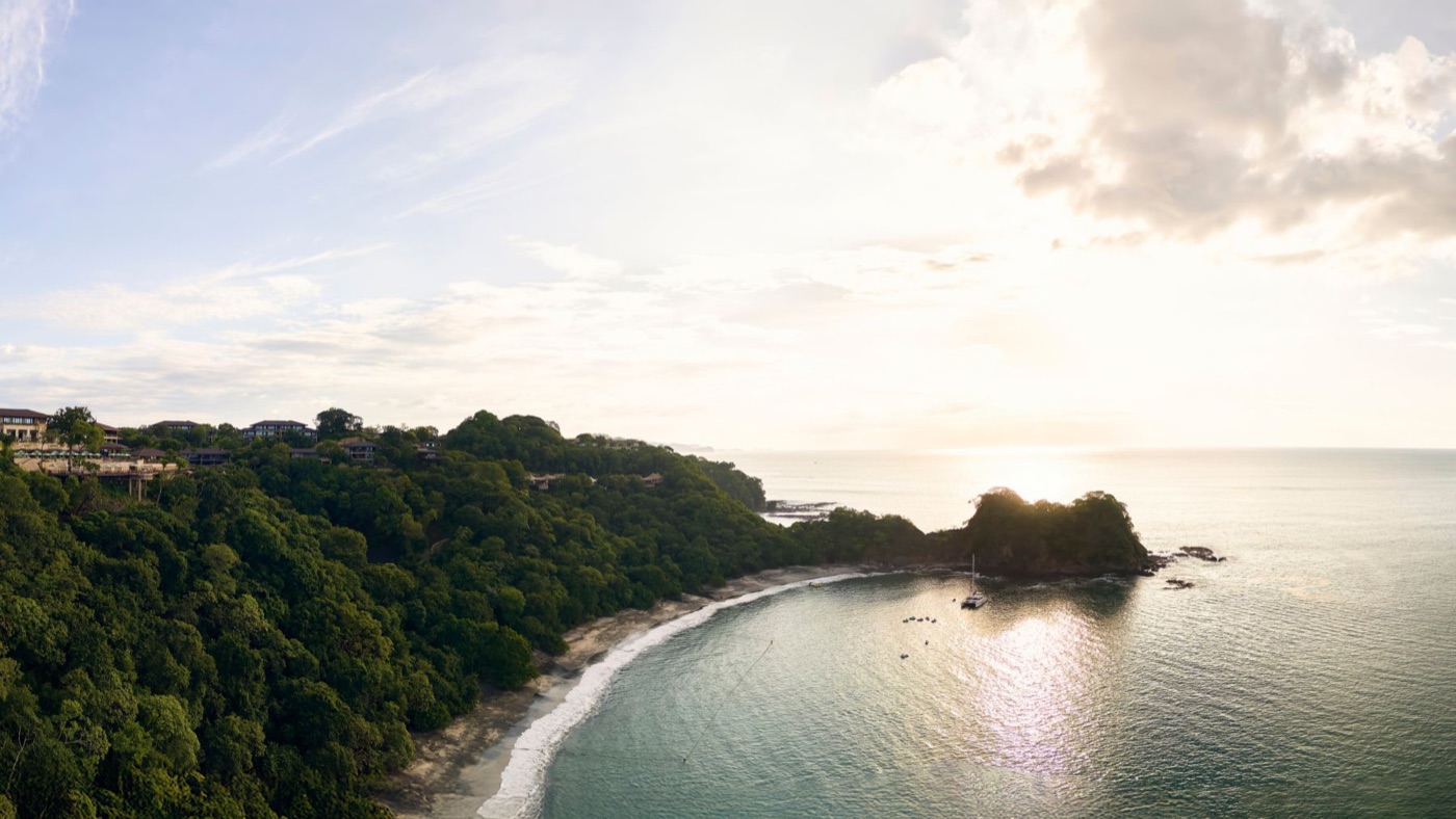 The forested Guanacaste coastline at sunset