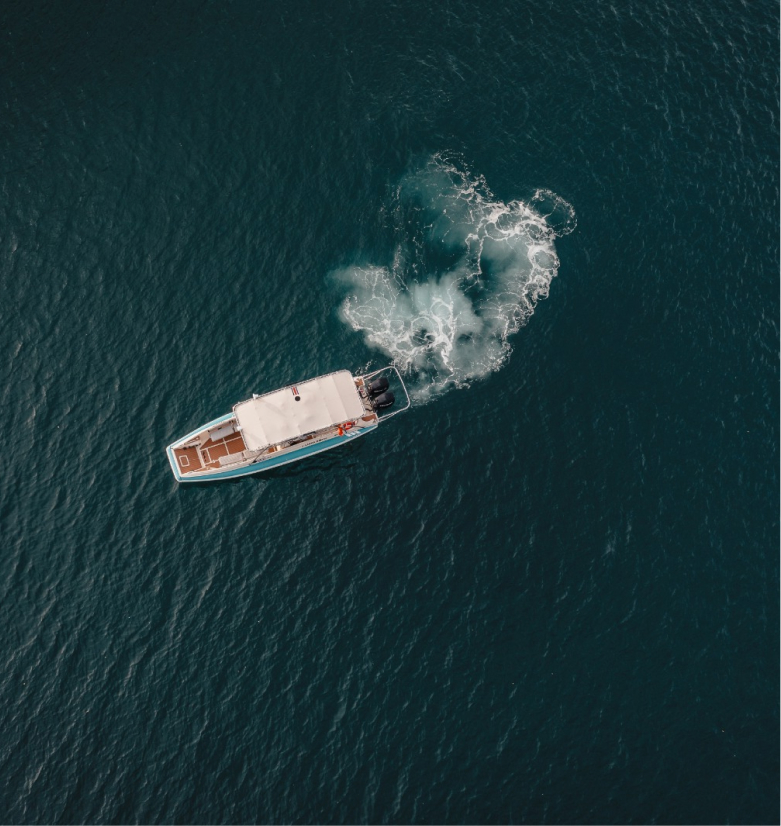 A boat crossing the deep blue water at Peninsula Papagayo